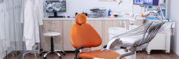 Dentist's office interior with modern chair and special dentisd equipment. The interior of stomatology clinic.